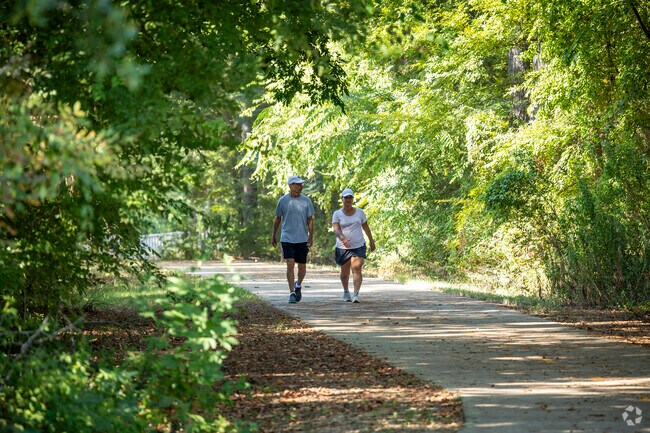 A couple enjoys a morning walk along the trails around The Crossing.