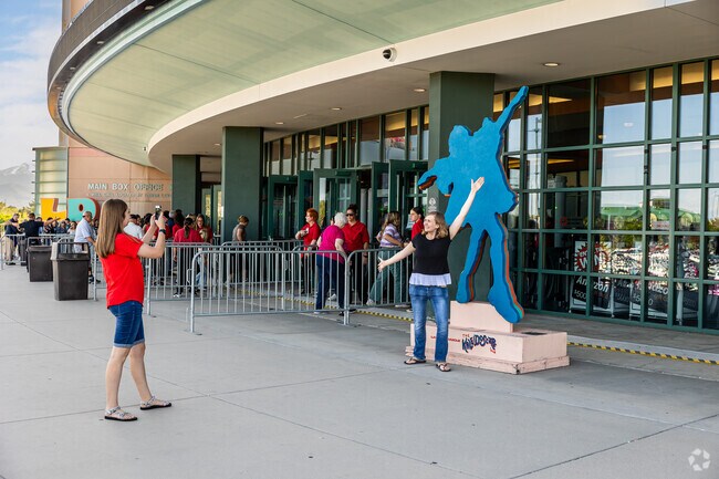A woman poses for a picture in front of the Maverick Center in Redwood.