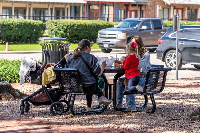 A family takes a break at one of League Park's many picnic areas, located in League City.