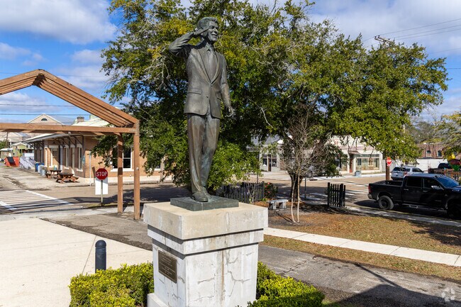 Visitors enjoy the Ronald Reagan statue at Tammany Trace Trailhead.