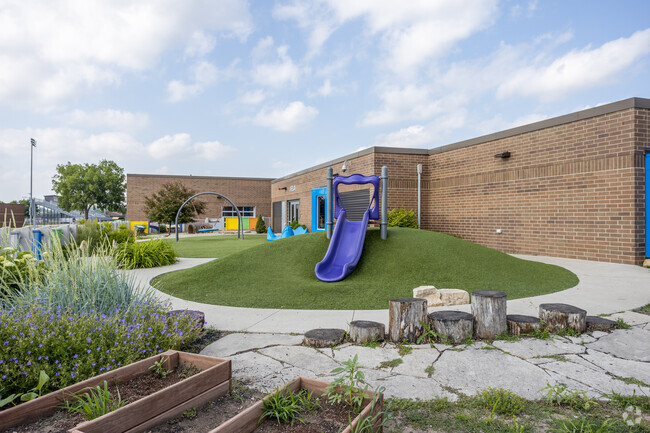 Children enjoy the Central Johnston outdoors at Henry A Wallace Elementary School's playground.