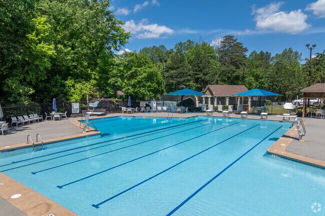 The Medlock Bridge neighborhood boasts several inviting pools, nestled amidst lush greenery and vibrant landscaping, providing residents and visitors with refreshing spots for relaxation and recreation.