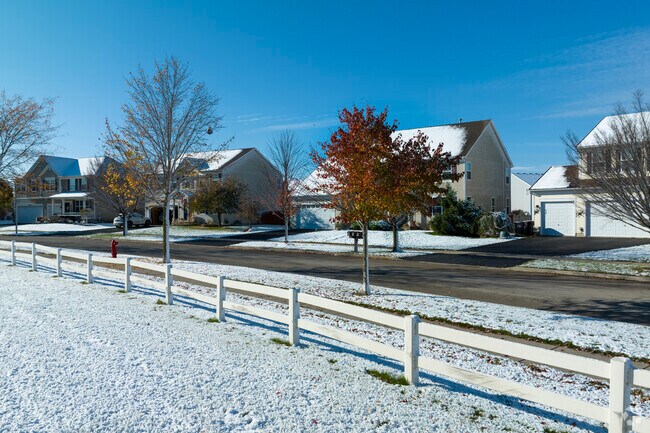 Newly developed homes and white picket fences line the streets of Ray Lake Kettle Grove.