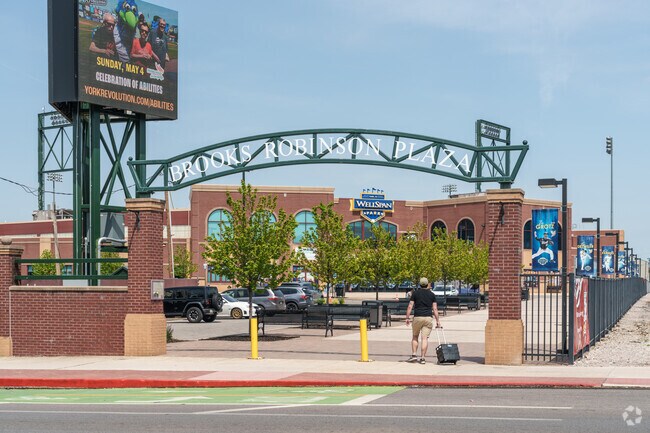 A vendor heads across Brooks Robinson Plaza toward WellSpan Park to get ready for the York Revolution game.