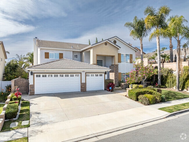 Large palm trees cover two story family homes in Juanamaria Oxnard, CA.