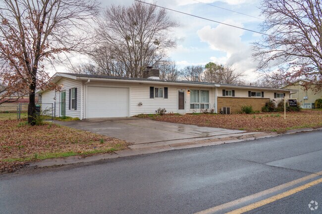 An older ranch home in Tahlequah exudes timeless charm, with its classic design and rustic character.