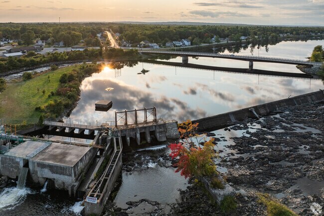 The setting sun reflects off the Penobscot River in Howland.