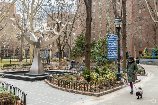 Residents take morning walks through StuyTown's green spaces.