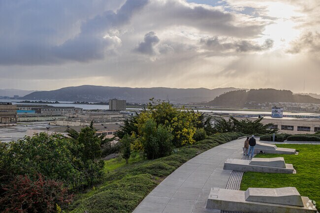 Evening bliss: A couple's walk with their dog in Hunters Point.