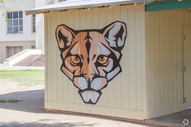 The Roskruge Bilingual Magnet K-8 School mascot is visible throughout the school's exterior.