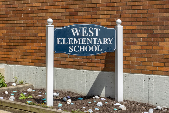 Signage in front of the West Elementary School in Long Beach, NY identify the school.