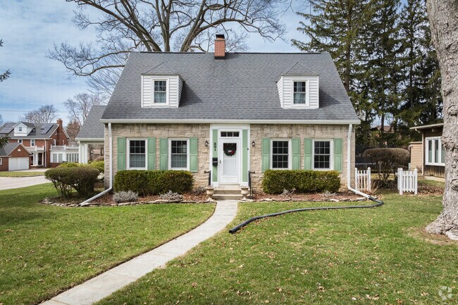 This Kenmore Cape Cod features colorful shutters and a manicured yard.