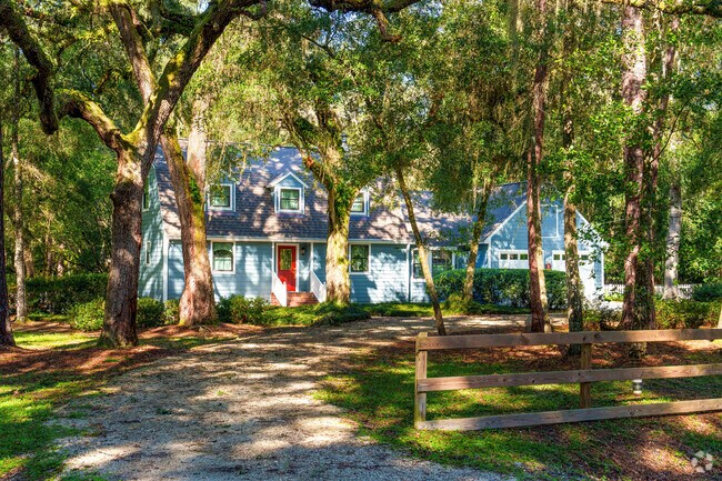 This beautiful blue two-story home in Sugarfoot features a red accent door.