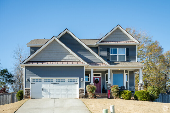 A Craftsman style home sitting on a small plot of land in Tigerville.