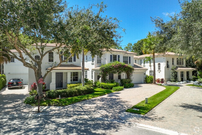 Tree-lined driveways welcome you home in Evergrene, Palm Beach Gardens.