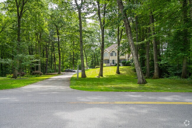 Some Plaistow homes have long driveways that stretch into well-forested areas.