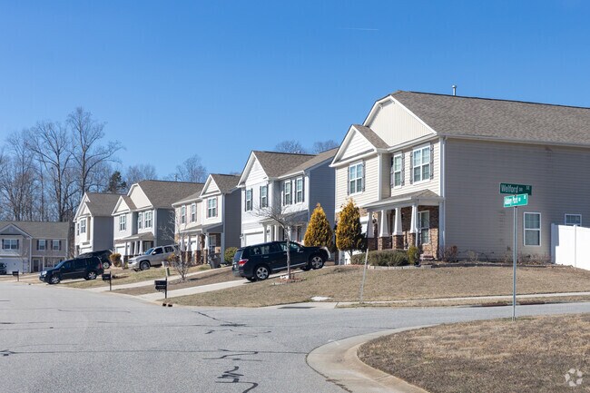 Houses surrounded by large trees and a well-kept garden in Oak Garden.