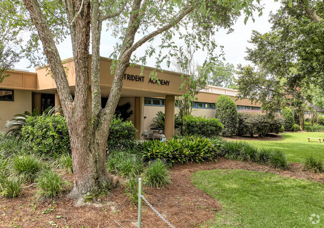 The original building is lush in landscape at Trident Academy in Mount Pleasant, SC.