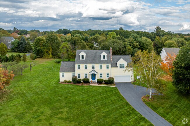 A colorful Colonial Revival styled home with a beautiful large lawn in Hitchingpost.
