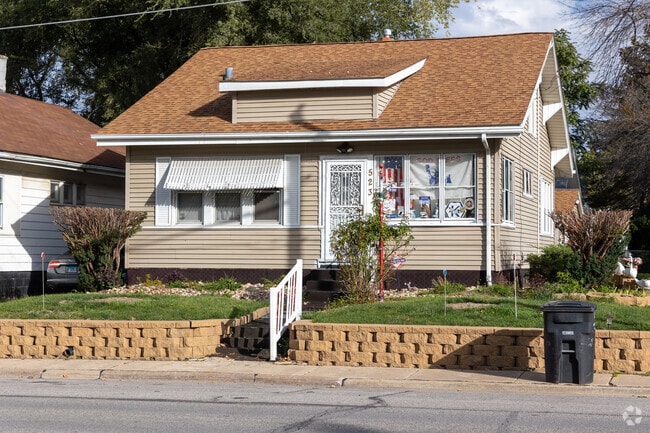 This West Central Rock Island home features an elevated yard and detached garage.