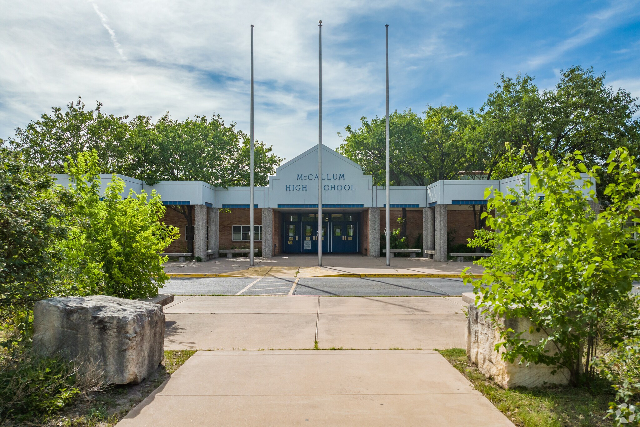 Alternate entrance view of building of McCalum High School.