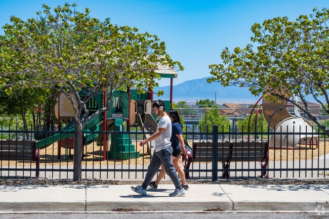 Locals walk around Tower Pond Park on a beautiful spring day.