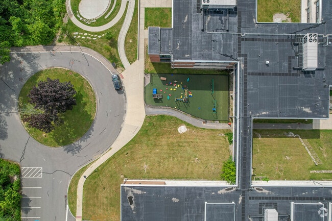 Hillside Elementary School playground has a field across from it in Needham.