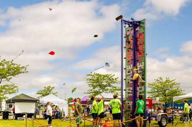 Kids climb the rock wall for fun at the International Kite Festival.