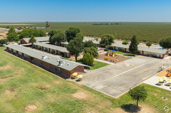 Cantua Elementary School provides large green areas and play equipment for students.