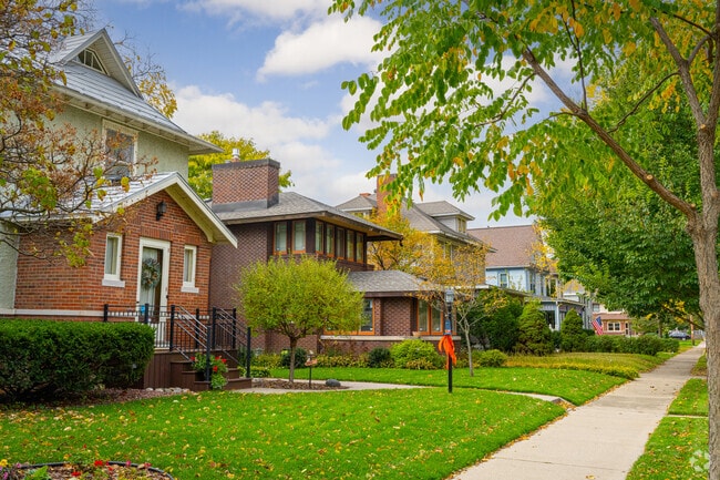 Brick homes line shaded streets with small lawns and sidewalks in Weigent-Hogan.