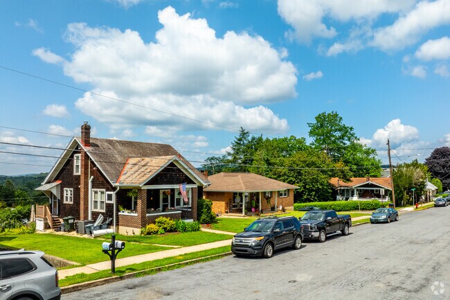 Sidewalk runs past bungalows and ranch homes on a quiet street in Bowmanstown, Pennsylvania.