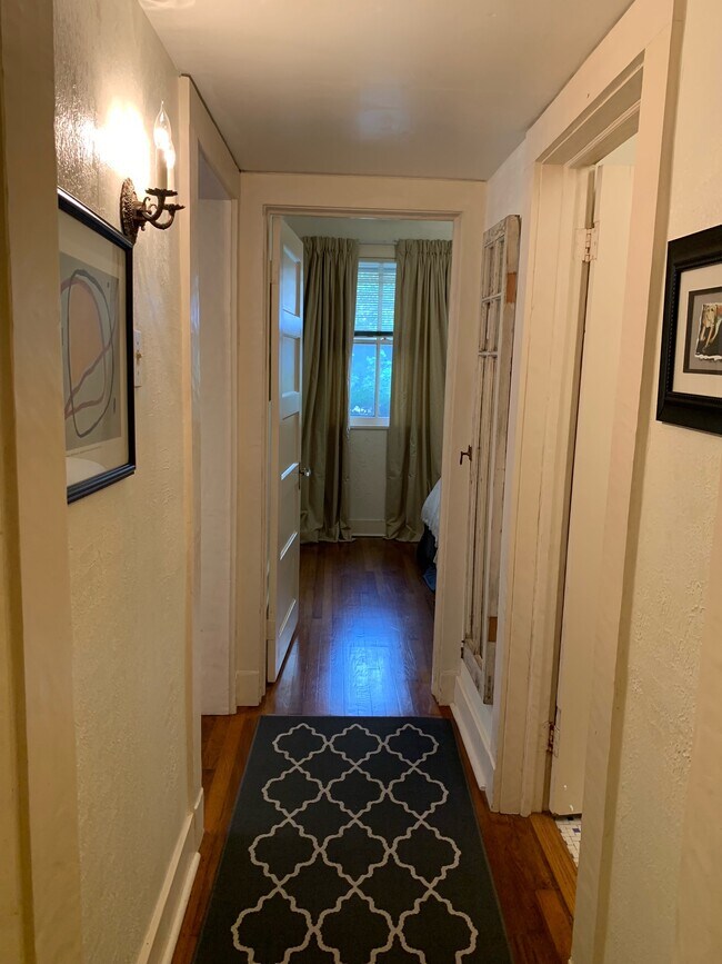 hallway linking kitchen, bedroom, and bathroom