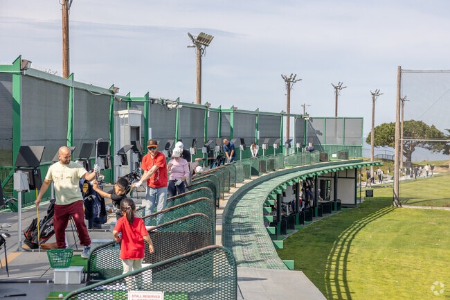 Golf enthusiasts practice their swing at Mariners Point Golf Center in Foster City.