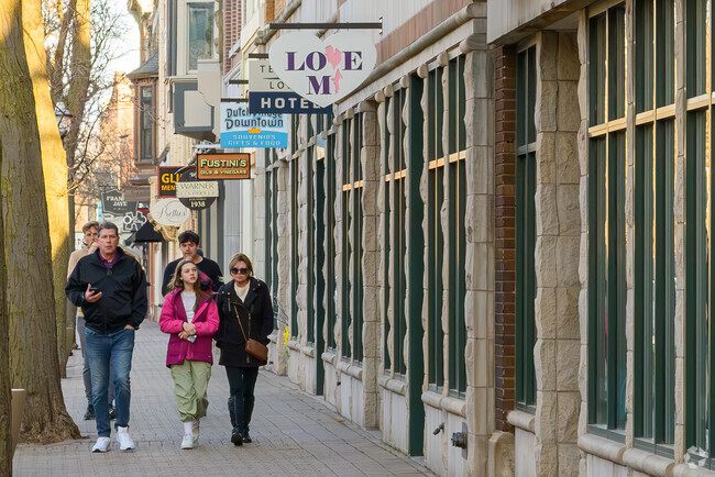 A family walks along the restaurants and shop of Downtown Holland, near Westside.