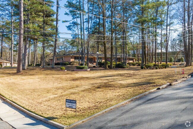 Imhotop Academy has multiple building spread across a forest filled campus.