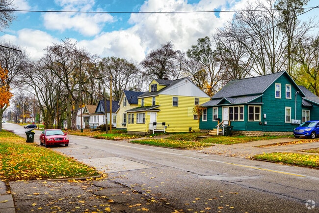 A row of bungalows and gablefront homes runs along a quiet street in Nims.