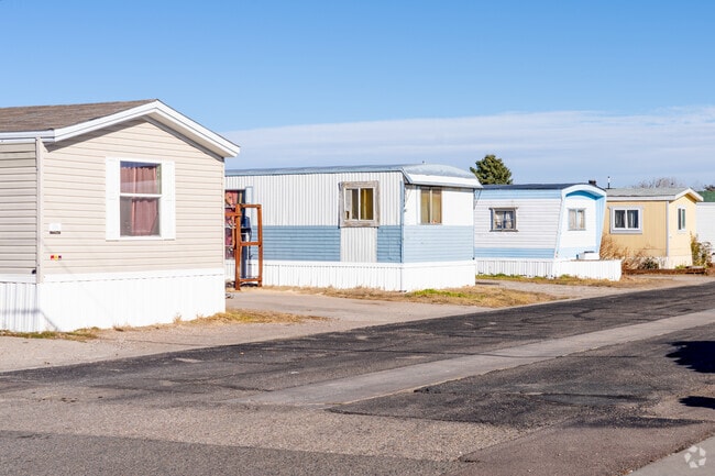 A row of trailer homes lined up in South Greeley, offering simple, affordable living.