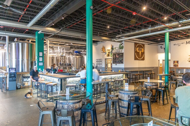 Greater Good Imperial Brewing Company has many table's and open bar seating.