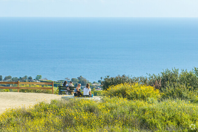 The Top of the World Trailhead leads to an open area with panoramic views of the ocean.