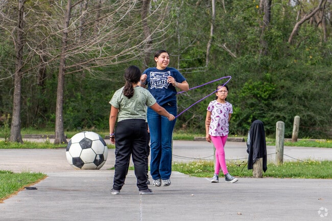 A group of friends play jump rope at Jacinto City's Herman Brown Park.