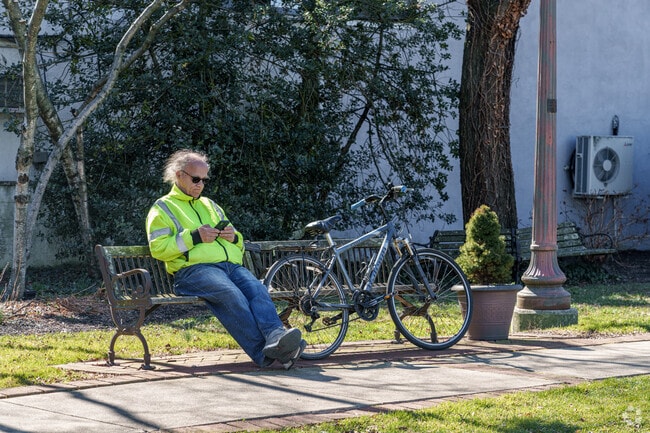 A cyclist takes a break on a park bench in Lansdowne.