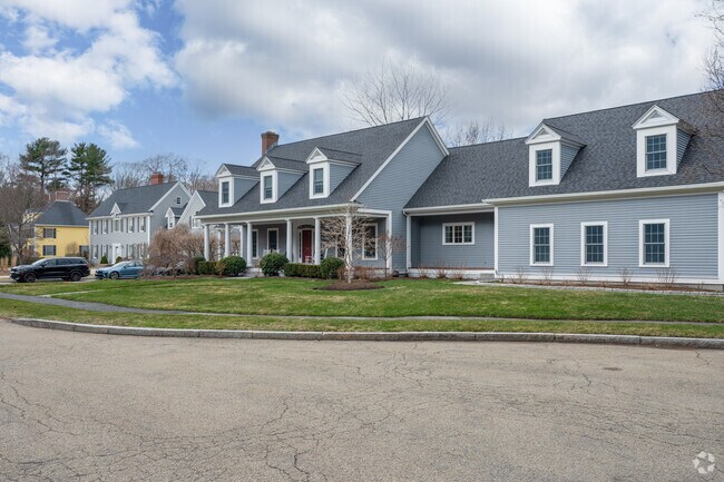 Spacious Cape Cod and Colonial-style homes line the road in the Hillside Street neighborhood.