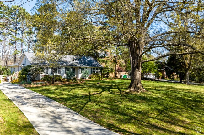 Large trees encompass the front yards of split-level homes in East Forest.