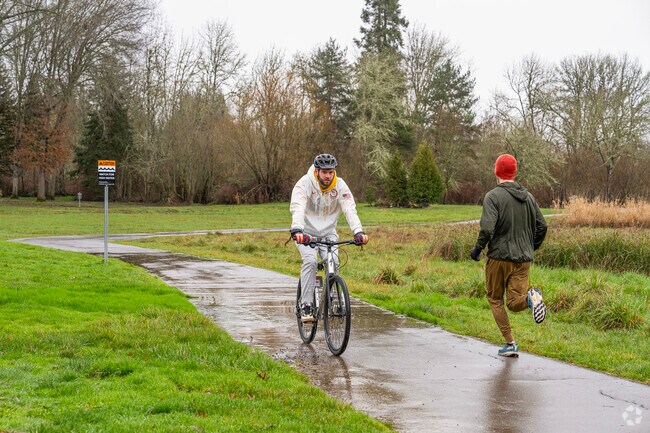 Run or ride bikes on Fanno Creek Trail at Greenway Park in Beaverton, OR.