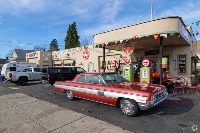 A classic automobile sits in front of a vintage restored gas station in Gladstone.