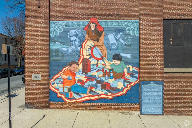A mural in 1st Ward, Allentown, shows children learning and collaborating in the arts.