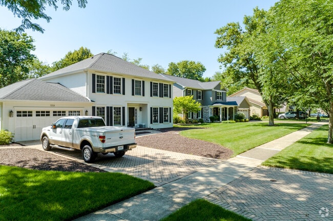 Colonial-style homes with attached garages line the streets of Steeple Run, Lisle.