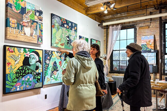 A painter discusses her art with attendees during the Open Casket art event.