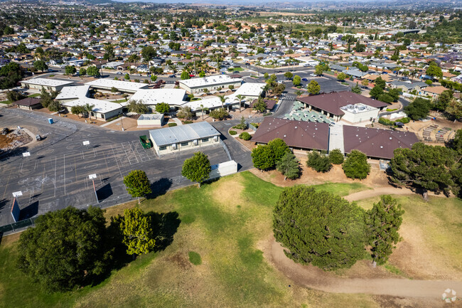 A side field, recess area, and blacktop are found at the Libby Elementary School campus.