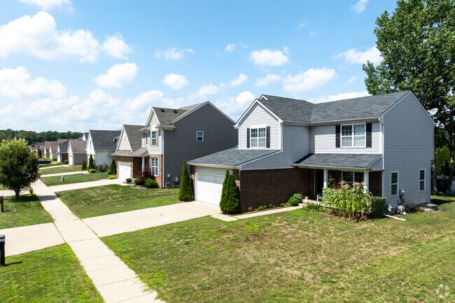Rows of single-family houses display well-maintained lawns throughout the neighborhood.
